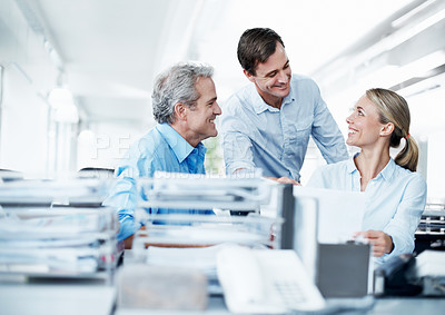 Buy stock photo Three businesspeople working together in their office