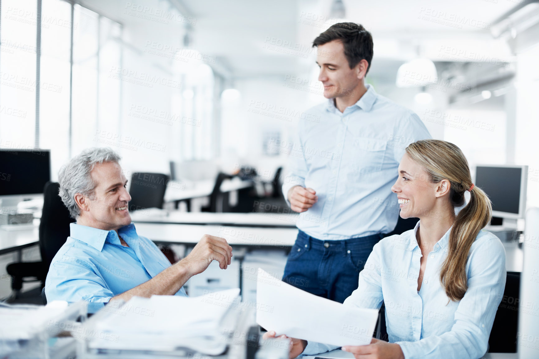 Buy stock photo Three businesspeople working together in their office