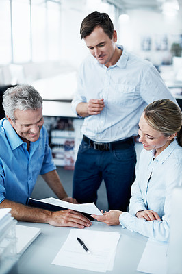 Buy stock photo Three businesspeople working together in their office