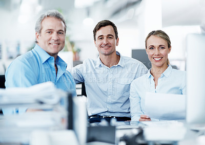 Buy stock photo Business colleagues smiling and sitting together in an open plan office space - portrait