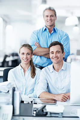 Buy stock photo Business colleagues smiling and sitting together in an open plan office space - portrait