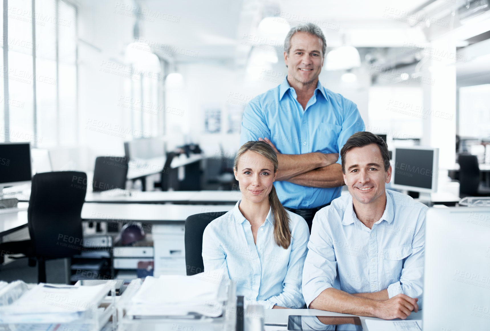 Buy stock photo Business colleagues smiling and sitting together in an open plan office space - portrait