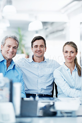 Buy stock photo Business colleagues smiling and sitting together in an open plan office space - portrait