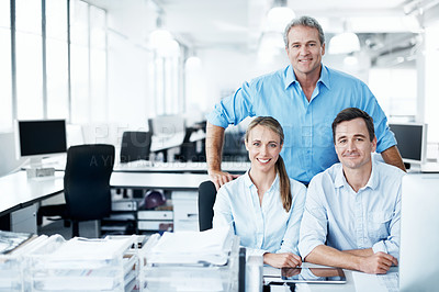 Buy stock photo Business colleagues smiling and sitting together in an open plan office space - portrait