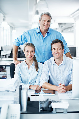 Buy stock photo Business colleagues smiling and sitting together in an open plan office space - portrait
