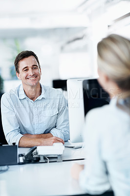 Buy stock photo Two young business colleagues discussing work in the office