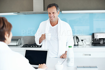 Buy stock photo Man, couple and coffee in kitchen with smile, relax and morning routine together with laptop and chat. Conversation, person and partner with drink at counter, happy and bonding on weekend at house