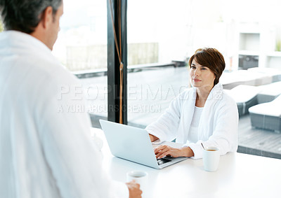Buy stock photo Woman, laptop and couple in home for planning, travel discussion and brainstorming in morning. People, computer and coffee in living room for anniversary trip, booking confirmation and bonding