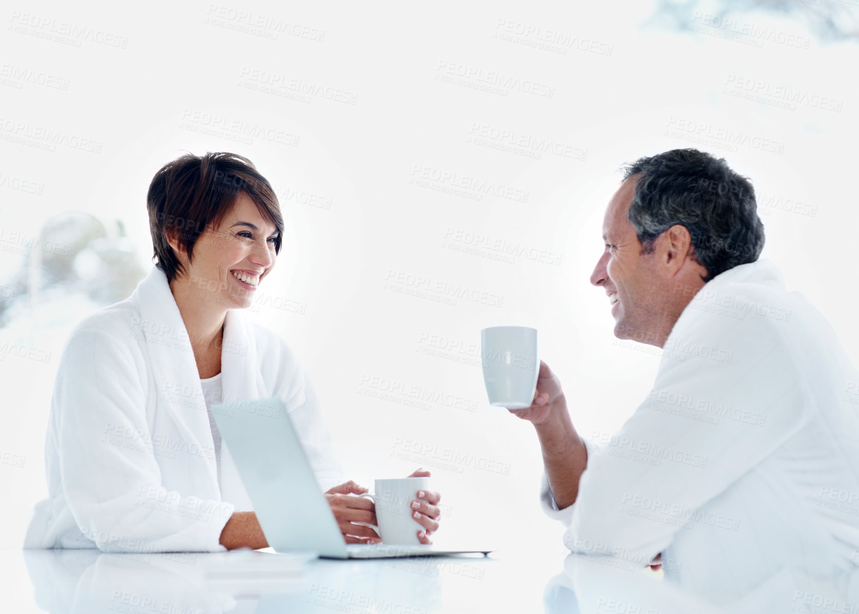 Buy stock photo Couple, talking and laugh in home with coffee for break, relax or morning start with drink. People, married and funny chat with beverage, happy and bonding for relationship and routine in house