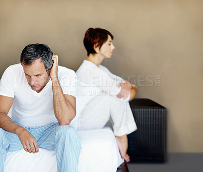 Buy stock photo Couple, man and upset in bedroom in home, disagreement and thinking of mistake or space in relationship. Partner, woman and problem in marriage, question commitment or risk of divorce with crisis