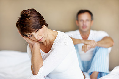 Buy stock photo Couple, woman and upset in bedroom with thinking at house, memory of mistake or relationship fail. Partner, man and problem in marriage, question commitment or risk of divorce with unhappy future