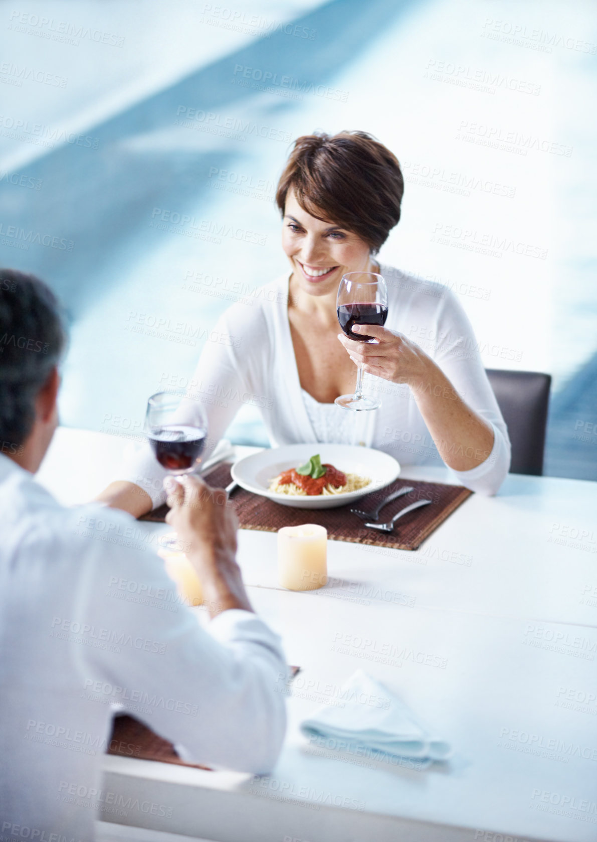 Buy stock photo Dinner, love and couple with red wine at date, connection and anniversary with partner from above. Happy woman, man and alcohol glass for romantic relationship, relax and support with pasta at home