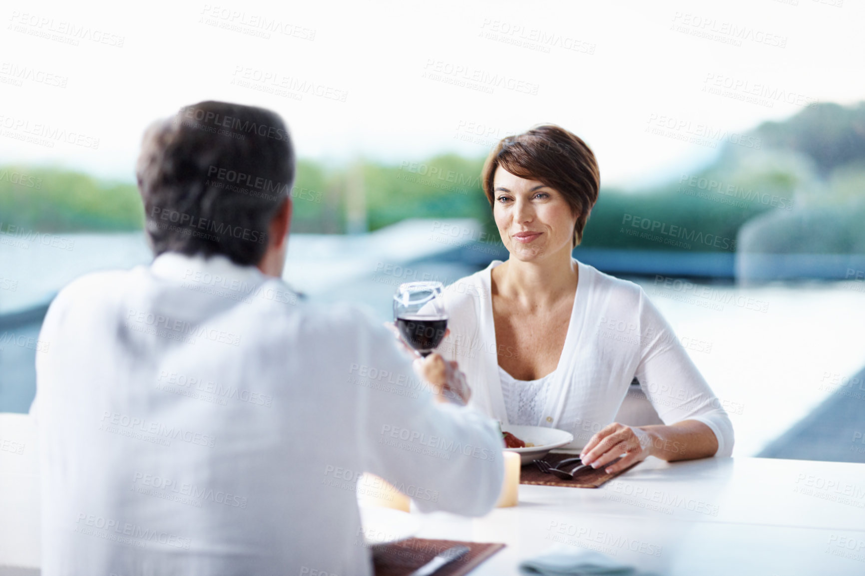 Buy stock photo Dinner, romance and couple cheers with red wine at date, connection and anniversary celebration. Happy woman, mature man and toast with alcohol for love, relationship and care with food at home