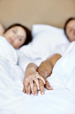 Buy stock photo Holding hands, couple and love in bed for connection, commitment and trust in relationship in home. Man, woman and relax in bedroom with loyalty, wellness and marriage unity for support and together