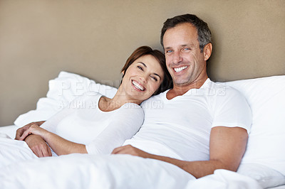Buy stock photo Love, portrait and smile with couple in bedroom in home for wake up, connection and romantic partner. Bonding, support and morning with man and woman in bed in apartment for trust, care and relax