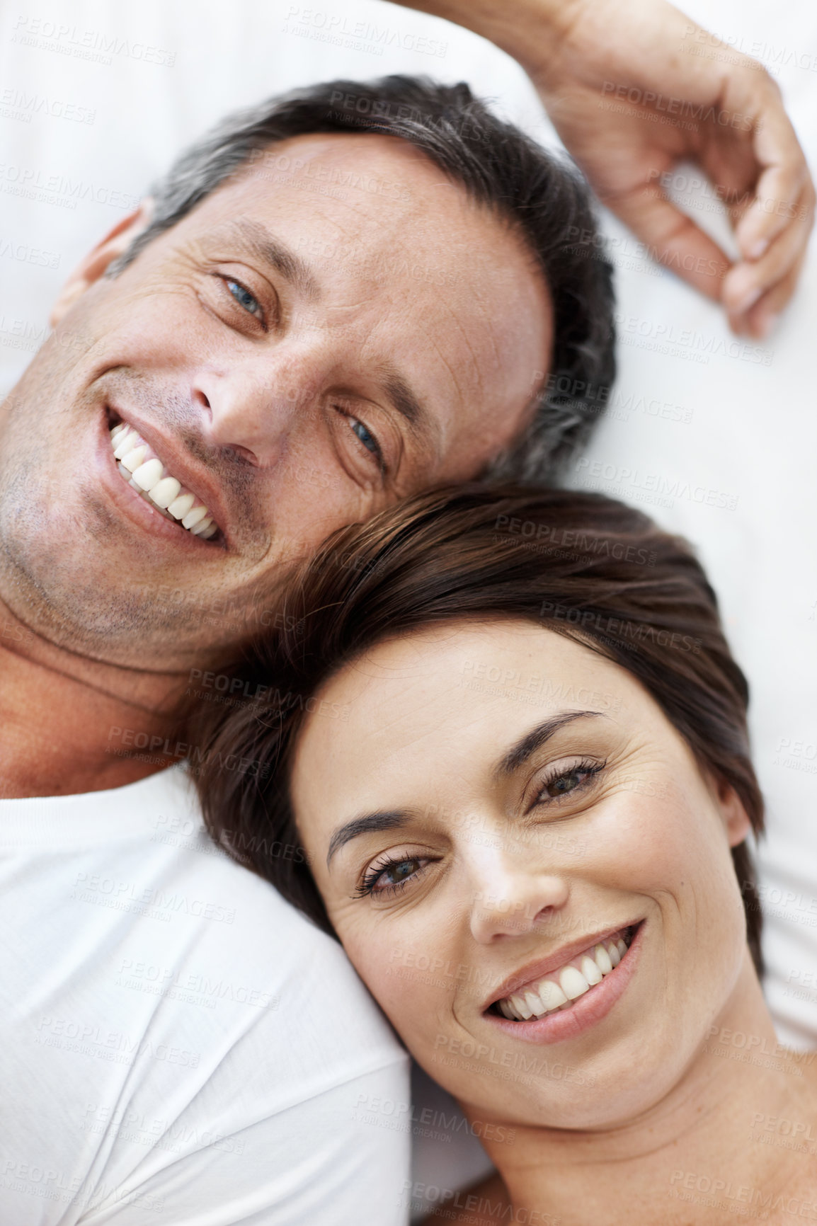 Buy stock photo Love, portrait and smile with couple in bedroom in home for wake up, connection and romantic partner. Bonding, support and morning with man and woman in bed in apartment for above, happy and care