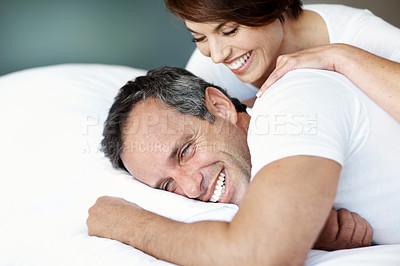 Buy stock photo Love, relax and laugh with couple in bedroom in home for wake up, connection and romantic partner. Bonding, support and morning with mature man and woman in bed in apartment for joke and care