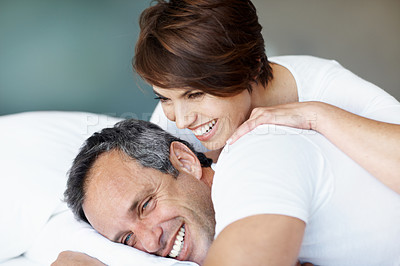 Buy stock photo Laugh, morning and relax with couple in bedroom for romance, valentines day and marriage support. Joke, getaway and care with man and woman in home or staycation for anniversary retreat and love