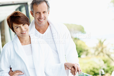 Buy stock photo Smile, couple and relax on balcony with love, affection and bonding together at holiday resort. Portrait, people and terrace at hotel with embrace, healthy relationship and commitment for vacation
