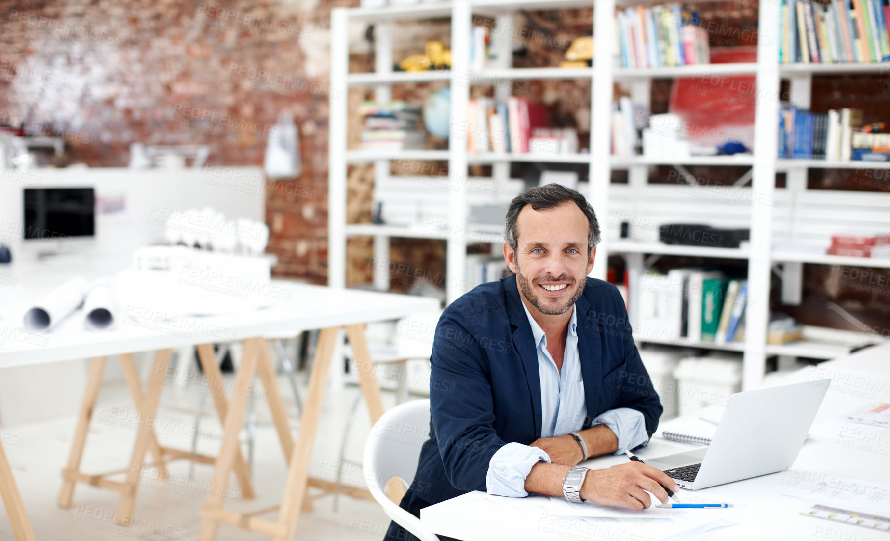 Buy stock photo Man, smile and portrait in office for architecture, civil engineering and laptop for design. Architect, mature person and blueprint planning, contractor or happy employee with confidence in workplace