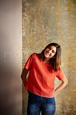 Buy stock photo Portrait of a young woman posing in front of a colorful wall