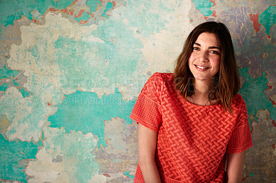 Buy stock photo Portrait of a young woman posing in front of a colorful wall