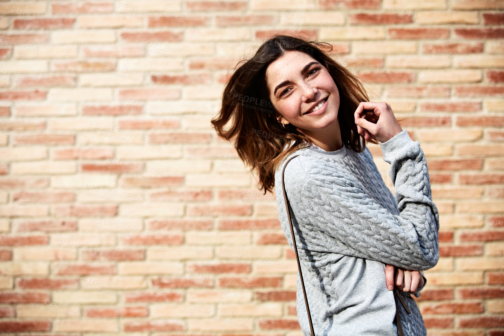 Buy stock photo Portrait, woman and student outdoor for smile, scholarship and exchange program for education. Happy, female person and space at brick wall for studying, college enrollment and learning opportunity