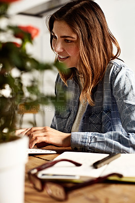 Buy stock photo Shot of a young woman typing on a computer keyboard