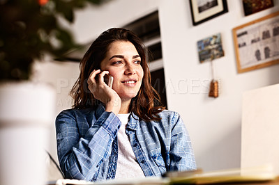 Buy stock photo Shot of a young woman talking on her phone indoors
