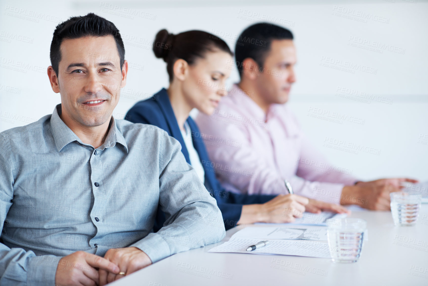 Buy stock photo Meeting, smile and portrait with business man in office for planning, budget report and about us. Account review, collaboration and consulting with employees in agency for feedback and update