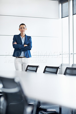 Buy stock photo Portrait of a young businesswoman standing in a conference room