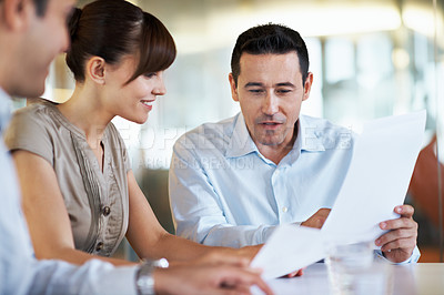 Buy stock photo Shot of coworkers discussing paperwork in a meeting