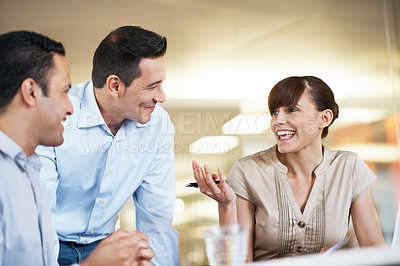 Buy stock photo Shot of three business colleagues having an office meeting