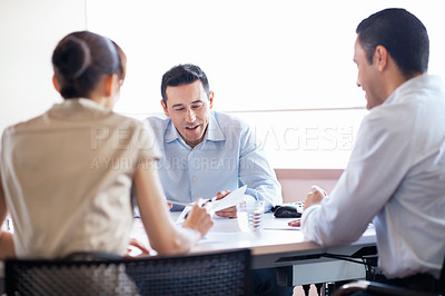 Buy stock photo Shot of businesspeople having an office meeting around a table