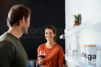 Buy stock photo Shot of a smiling mature couple drinking wine in their kitchen