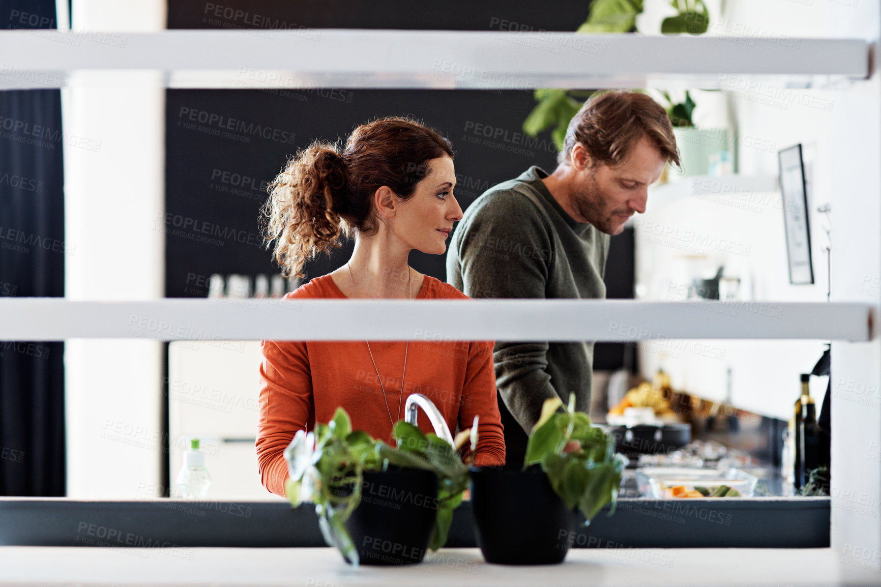 Buy stock photo Couple, cooking and love with recipe in kitchen for diet, nutrition or together for dinner. Man, woman and support with fresh herbs, ingredients or food with conversation for meal prep in home