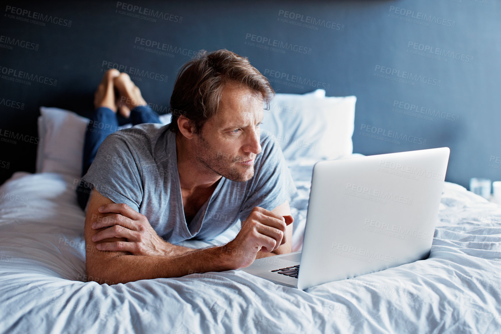 Buy stock photo Man, relax and search with laptop in bedroom for movie, streaming film or online video. Mature person, home and digital tech for social media, podcast and break on weekend for internet entertainment