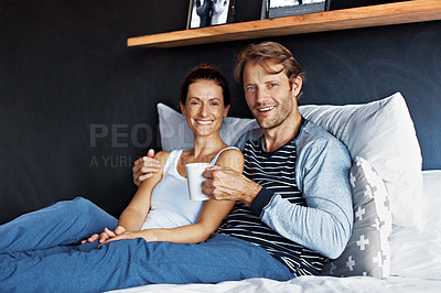 Buy stock photo Portrait of a content mature couple sitting on their bed together