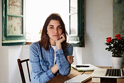 Buy stock photo Portrait of a smiling young woman sitting at a desk