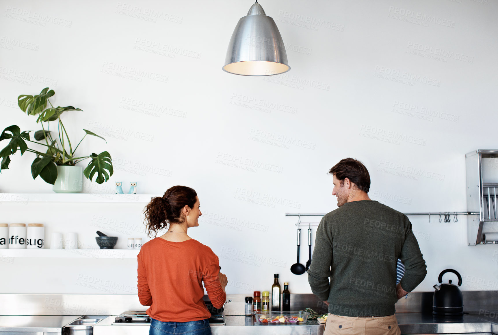 Buy stock photo Rearview shot of a mature couple cooking in their kitchen
