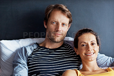 Buy stock photo Portrait of an affectionate mature couple lying in bed together