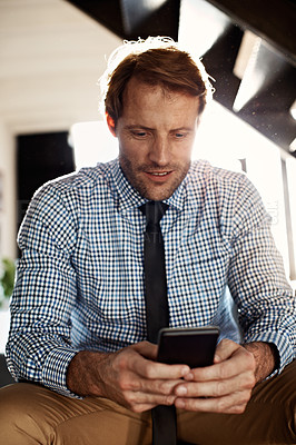 Buy stock photo Shot of a man reading a text message