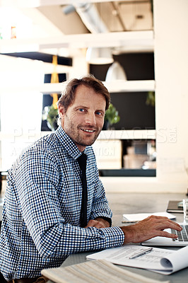 Buy stock photo Portrait of a smiling man working on a laptop