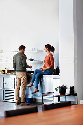 Buy stock photo Shot of a happy couple cooking together in their kitchen