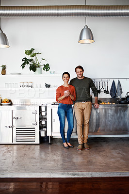 Buy stock photo Portrait of a smiling couple standing in their kitchen