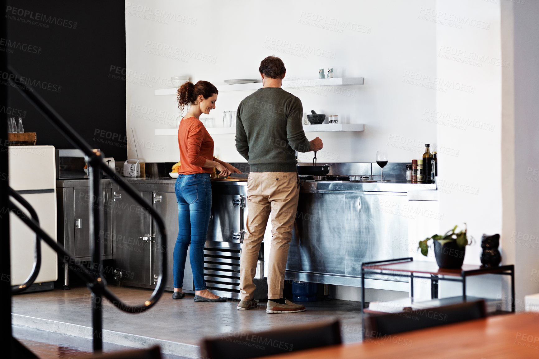 Buy stock photo Rearveiw shot of a mature couple cooking in their kitchen