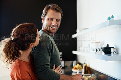 Buy stock photo Shot of a smiling mature couple cooking together in the kitchen