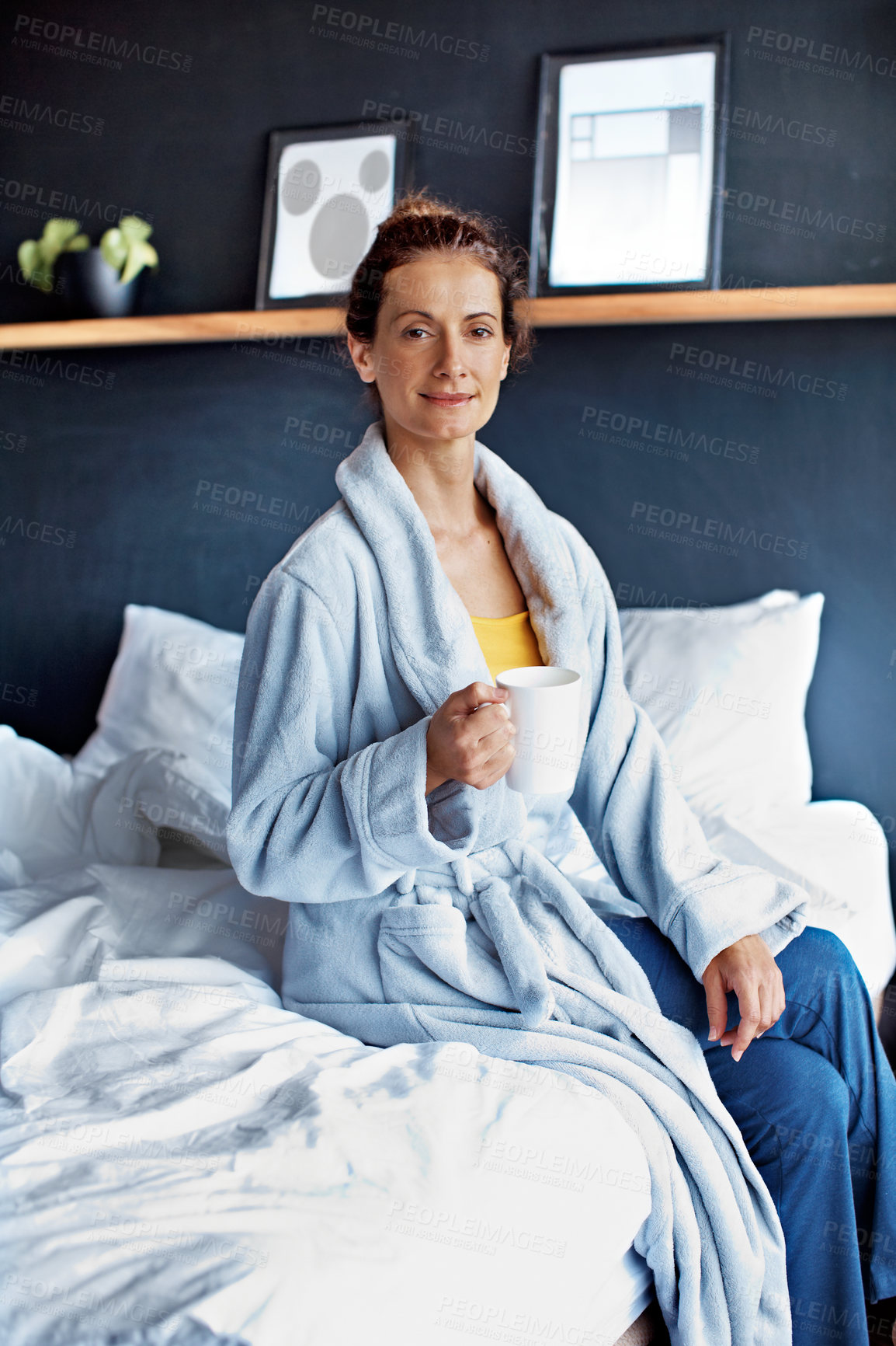 Buy stock photo Portrait of a mature woman sitting on her bed drinking a coffee