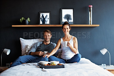 Buy stock photo Portrait of a smiling mature couple enjoying breakfast in bed