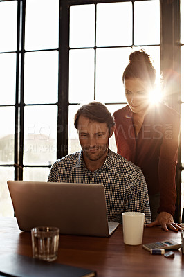 Buy stock photo Shot of a couple working at their dining table